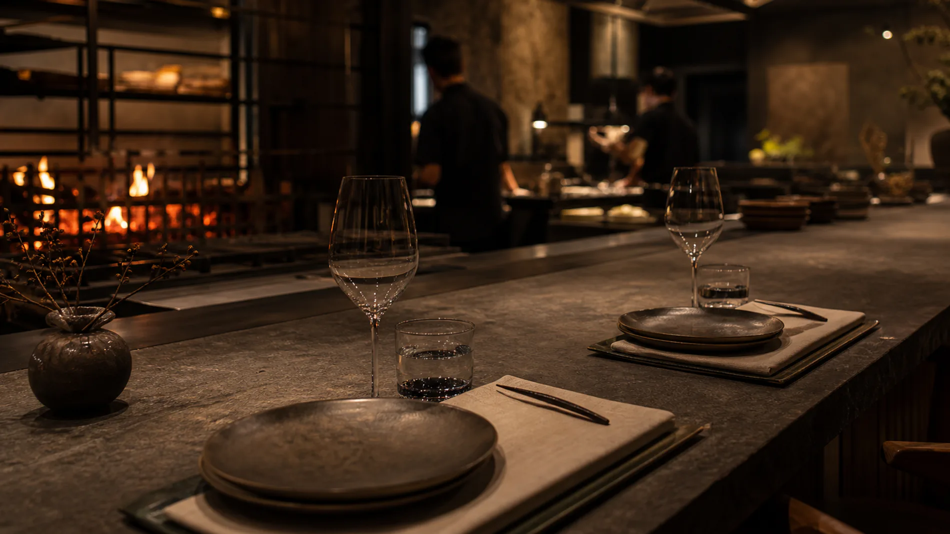Place settings at the chef's counter facing the open fire kitchen.